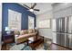 Sitting area with a couch, coffee table, stainless steel fridge, and natural light at 118 Brighton Blvd, Woodstock, GA 30188