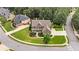 Areal view of a large 2 story home with a well manicured lawn in a residential neighborhood at 134 Lakestone Pkwy, Woodstock, GA 30188