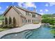 Spacious backyard with a private pool, covered patio, and well-maintained landscaping, perfect for outdoor living at 134 Lakestone Pkwy, Woodstock, GA 30188