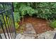 Multi-level backyard featuring steps to a wooded area filled with native plants and greenery at 134 Lakestone Pkwy, Woodstock, GA 30188