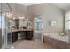 Bright bathroom with shower, tub, and vanity featuring granite counters at 134 Lakestone Pkwy, Woodstock, GA 30188