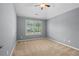 Bright bedroom with large windows and neutral carpet at 134 Lakestone Pkwy, Woodstock, GA 30188