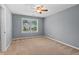 Comfortable bedroom with a large window and neutral carpet flooring at 134 Lakestone Pkwy, Woodstock, GA 30188