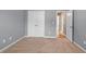 Bedroom features a double door closet, neutral carpet and paint, and view of hallway at 134 Lakestone Pkwy, Woodstock, GA 30188