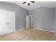 Bedroom with neutral carpet, double door closet, ceiling fan, and doorway to hall at 134 Lakestone Pkwy, Woodstock, GA 30188