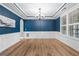 Dining room boasting sleek hardwood flooring, decorative molding, and natural light from the expansive window at 134 Lakestone Pkwy, Woodstock, GA 30188