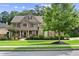 Beautifully landscaped two-story home with a stone facade and manicured front yard, perfect curb appeal at 134 Lakestone Pkwy, Woodstock, GA 30188