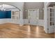 Elegant foyer featuring hardwood floors, wainscoting, and a view of the formal dining area, ideal for entertaining at 134 Lakestone Pkwy, Woodstock, GA 30188
