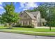 Beautiful home with a well-maintained lawn, mature trees, and a basketball hoop, perfect for outdoor enjoyment and curb appeal at 134 Lakestone Pkwy, Woodstock, GA 30188