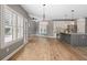 Open kitchen and dining area with hardwood floors, stainless appliances, and granite countertops at 134 Lakestone Pkwy, Woodstock, GA 30188