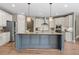 Kitchen island featuring granite countertop and gray cabinets with stainless steel appliances at 134 Lakestone Pkwy, Woodstock, GA 30188