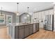 Kitchen island with gray cabinetry, granite countertops, stainless appliances, and pendant lighting at 134 Lakestone Pkwy, Woodstock, GA 30188