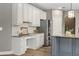 Kitchen featuring white cabinets, granite countertops, stainless steel refrigerator and matching backsplash at 134 Lakestone Pkwy, Woodstock, GA 30188