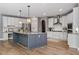 Modern kitchen featuring a large island, stainless steel appliances, custom cabinetry, and hardwood floors at 134 Lakestone Pkwy, Woodstock, GA 30188