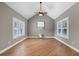 Living room with hardwood floors, a ceiling fan, and windows with plantation shutters at 134 Lakestone Pkwy, Woodstock, GA 30188