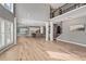 Open living room showcasing hardwood floors, soaring ceilings, and seamless flow into the modern kitchen at 134 Lakestone Pkwy, Woodstock, GA 30188