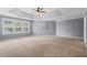 Spacious main bedroom boasts a tray ceiling, large windows, and neutral decor at 134 Lakestone Pkwy, Woodstock, GA 30188
