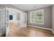 Bright office space with hardwood floors, natural light, and elegant French doors leading to the formal dining room at 134 Lakestone Pkwy, Woodstock, GA 30188