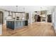 Spacious open-concept kitchen and living area featuring a large island and a stone fireplace at 134 Lakestone Pkwy, Woodstock, GA 30188