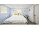 Serene bedroom with pale blue walls, two windows, and a white headboard bed, creating a peaceful retreat at 3251 Auburn Ave, Dacula, GA 30019