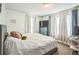 Comfortable bedroom with natural light, a plush bed, and soft curtains for a relaxing and restful atmosphere at 3251 Auburn Ave, Dacula, GA 30019