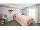 Cozy bedroom featuring comfortable carpeting, a plush bed, and soft natural light from the window at 3251 Auburn Ave, Dacula, GA 30019