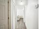 Bright hallway with wood-look flooring and crisp white walls, leading to the living room at 3251 Auburn Ave, Dacula, GA 30019