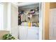 Convenient laundry area with stacked washer and dryer, enclosed with white louvered doors for a clean look at 3251 Auburn Ave, Dacula, GA 30019