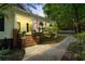 Inviting front porch with brick accents, American flag, and manicured landscaping at 4728 Corn Creek Drive, Fairburn, GA 30213