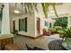 Covered porch with brick detail, ceiling fans, and outdoor furniture create a charming outdoor living space at 4728 Corn Creek Drive, Fairburn, GA 30213