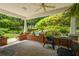 Inviting outdoor space with ceiling fan and brick detail looking out to the lush, landscaped backyard at 4728 Corn Creek Drive, Fairburn, GA 30213