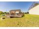 Manicured backyard with deck, pool, green grass, and mature trees at 15 Cobblestone Ct, Douglasville, GA 30134