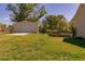 Large, grassy backyard featuring a detached garage and wooden deck at 15 Cobblestone Ct, Douglasville, GA 30134