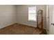 Minimalist bedroom featuring neutral walls, wood mirror and carpet at 15 Cobblestone Ct, Douglasville, GA 30134