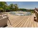 Wooden deck area with lounge chairs and furniture adjacent to the in-ground pool at 15 Cobblestone Ct, Douglasville, GA 30134