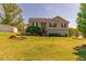 Charming two-story home with stone accents, dark shutters, a manicured lawn, and a detached garage to the rear at 15 Cobblestone Ct, Douglasville, GA 30134