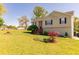 Inviting home with a lush lawn and landscaped garden beds at 15 Cobblestone Ct, Douglasville, GA 30134