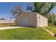 Features a modern metal garage with a roll-up door, side entrance, and convenient concrete driveway on a well-maintained lawn at 15 Cobblestone Ct, Douglasville, GA 30134