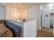 Hallway with a pendant light fixture leads to a bathroom with a tiled shower at 15 Cobblestone Ct, Douglasville, GA 30134