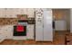 Kitchen area featuring appliances, tile backsplash, and tiled floor at 15 Cobblestone Ct, Douglasville, GA 30134
