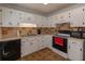 Bright kitchen with white cabinets, modern appliances, and tile backsplash at 15 Cobblestone Ct, Douglasville, GA 30134
