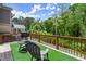 Outdoor deck with synthetic grass, outdoor seating, and wooded views at 1744 Habershal Nw Rd, Atlanta, GA 30318