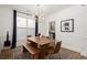 Bright dining room with wood table, stylish chandelier, and view of the kitchen at 1744 Habershal Nw Rd, Atlanta, GA 30318