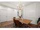 Formal dining room with paneled walls, hardwood flooring, and a modern chandelier at 1744 Habershal Nw Rd, Atlanta, GA 30318