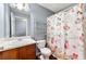 Bathroom with floral shower curtain, tile flooring, and single sink vanity at 4413 Pinscher St, Union City, GA 30291