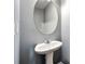 Bathroom featuring a pedestal sink and an oval mirror at 4413 Pinscher St, Union City, GA 30291