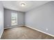 Bedroom featuring gray walls, carpet flooring, and a window for natural light at 4413 Pinscher St, Union City, GA 30291