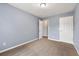 Bedroom with grey walls, neutral carpet, and open closet door at 4413 Pinscher St, Union City, GA 30291