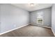 Neutral bedroom featuring gray walls, carpet flooring, and a window for natural light at 4413 Pinscher St, Union City, GA 30291