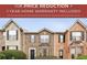 Charming townhome showcasing a brick facade, complemented by meticulously manicured landscaping and symmetrical shuttered windows at 4413 Pinscher St, Union City, GA 30291